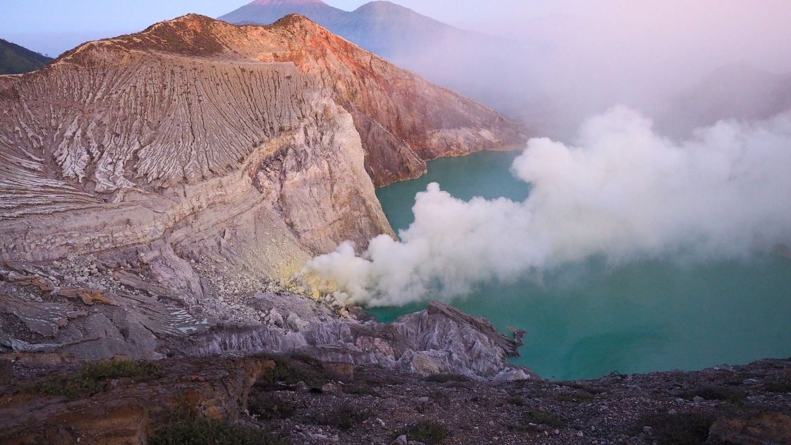 Ijen Crater turquoise acid lake during sunrise Banyuwangi