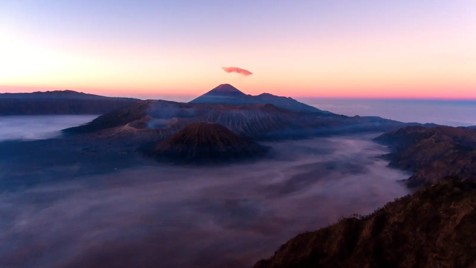 Jeeps parked at the base of the Bromo crater during sunrise