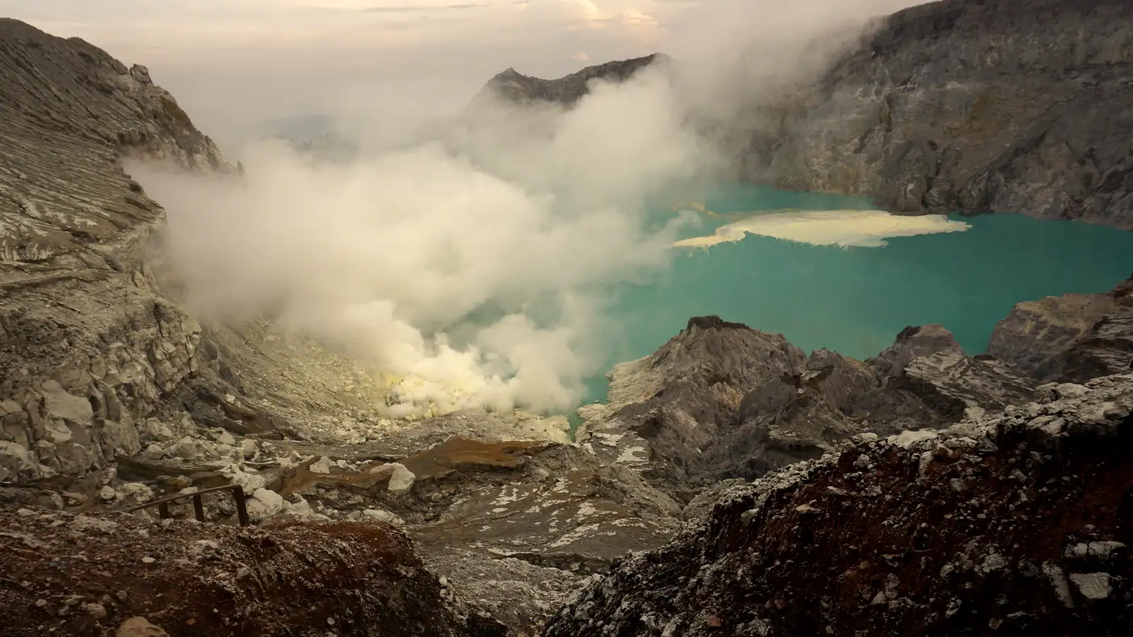 Close up of a sulfur miner carrying heavy baskets of volcanic sulfur at Ijen