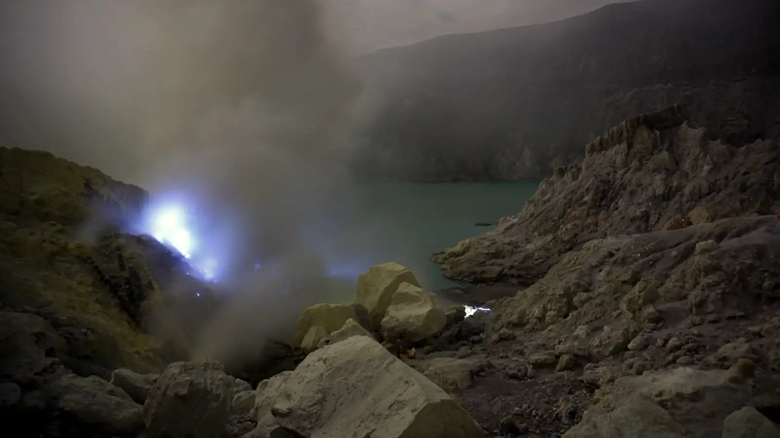 Photographer capturing the blue fire at Ijen Crater with a tripod