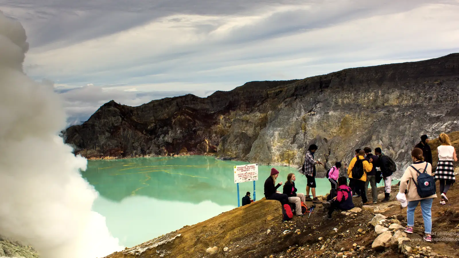The Majestic Ijen Crater at Sunrise Vibrant acidic lake and sulfur clouds at Ijen Crater during the dry season trekking