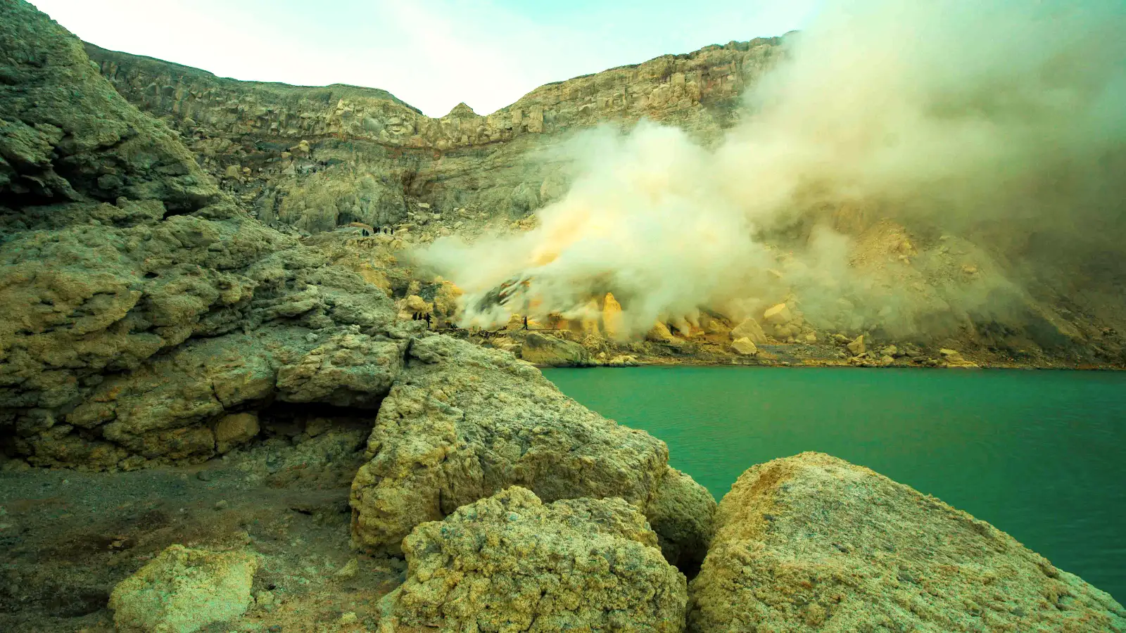 The Heavy Weight of Sulfur Mining Miners weighing sulfur at the collection point