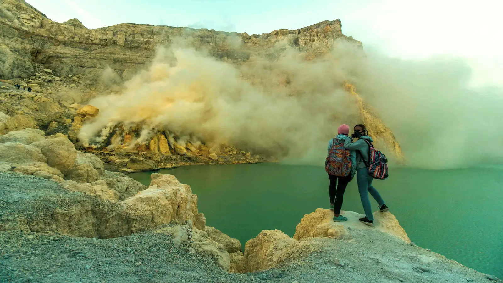 Tourist posing at the edge of Ijen Crater