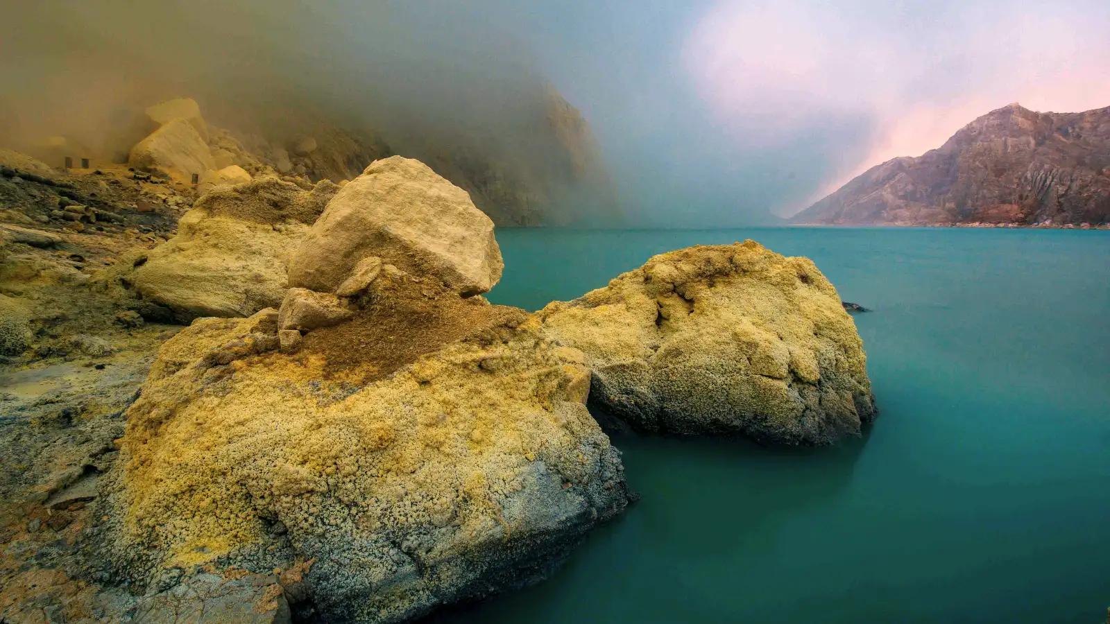 The harsh reality of sulfur mining at Ijen Sulfur miners working near the acidic turquoise lake of Ijen