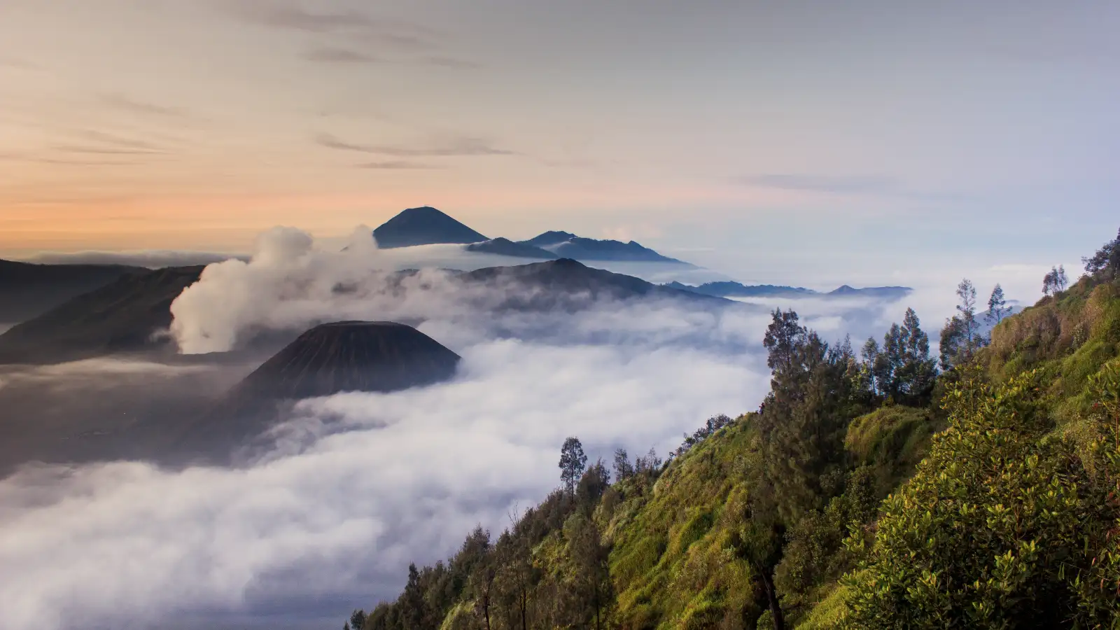Breathtaking dawn at Mentigen Hill Sunrise view from Mentigen Hill overlooking Mount Bromo and Batok