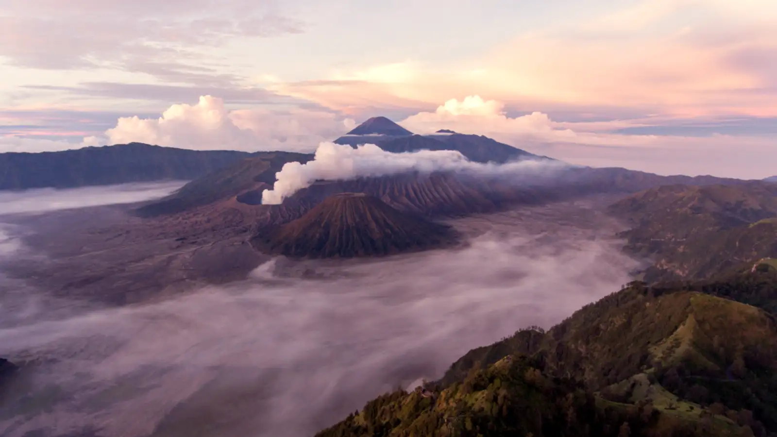 Stunning turquoise acid lake of Mount Ijen at sunrise