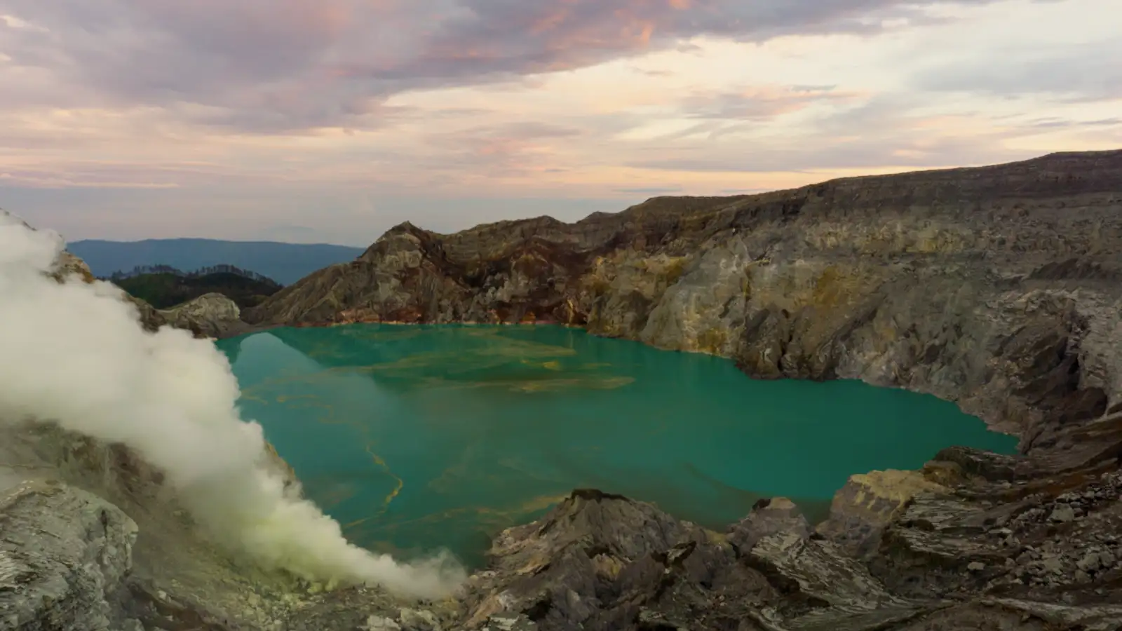 Sulfur miners carrying heavy baskets at Ijen Crater