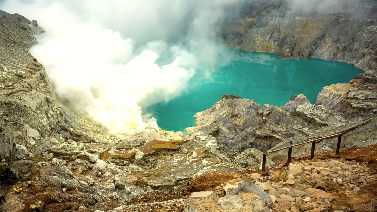 Hiking boots and gear on a rocky trail at Ijen Crater