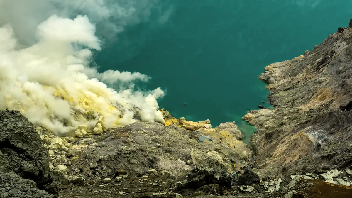 Sunrise over the turquoise Ijen Crater Lake in East Java